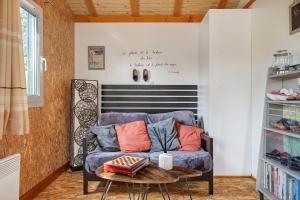 a living room with a blue couch and a table at Chalet Sein Dans Parc Résidentiel in Pléneuf-Val-André