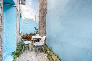 two chairs and a table in an alley at Katia's Home in Rhodes Town