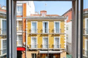 a view of a building from a window at Apartamento Bilua in Luanco