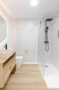 a bathroom with a sink and a shower at Apartamento Bilua in Luanco +26 photos