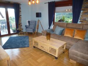 a living room with a couch and a coffee table at Ferienwohnung Pusteblume in Forbach