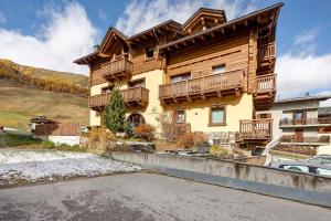 a large wooden house with balconies on a street at Livigno Wooden House in Livigno