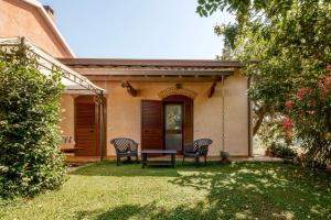 a house with two chairs and a table in the yard at Agriturismo Col Moschin in Grosseto +48 photos