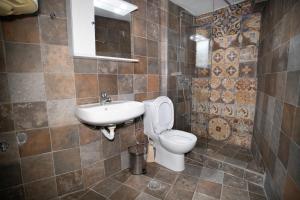 a bathroom with a toilet and a sink at Mani Tsopakas Residences Nest studio in Kafióna