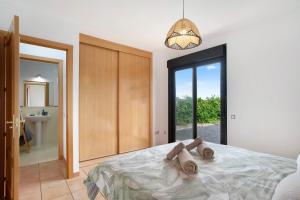 a person laying on a bed in a bedroom at Casa Vicente Majanicho in Lajares +23 photos