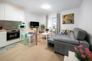 a living room with a couch and a kitchen at Capricho Torre del mar in Torre del Mar +15 photos