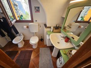 a bathroom with a sink and a toilet and a mirror at La Torre Medievale in Triora +43 photos