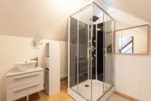 a bathroom with a glass shower and a sink at Chalet Confortable 14 voyageurs in Urdos +22 photos