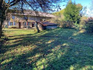 a large yard with a building in the background at Chez Bonneau in Nantiat