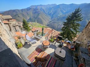 a dog standing on a patio with a view of mountains at La Torre Medievale in Triora