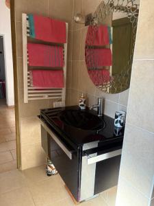 a bathroom with a black sink and a mirror at mas provençale jardin piscine in Saint-Cyr-sur-Mer +18 photos