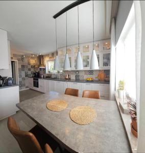 a large kitchen with a table and chairs in it at Dream house with garden in Kalmar
