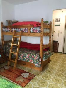 a bedroom with two bunk beds in a room at L'oasi dei larici - Montoso in Bagnolo Piemonte