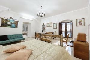 a bedroom with a bed and a dining room at Mikiami Semplicemente Accogliente in Monte SantʼAngelo