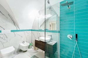 a bathroom with a sink and a toilet and a mirror at Mikiami Semplicemente Accogliente in Monte SantʼAngelo +20 photos