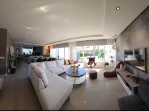 a living room with a white couch and a table at Dream house with garden in Kalmar