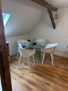 a dining room with a glass table and chairs at Modern Apartment in Bebra