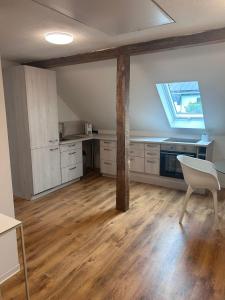 an empty kitchen with a table and a window at Modern Apartment in Bebra