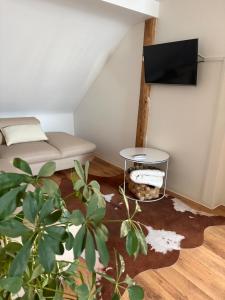 a small room with a bed and a table at Modern Apartment in Bebra +3 photos