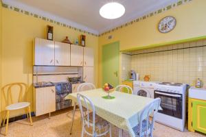 a kitchen with a table and a kitchen with a stove at La Coustouline in Lacoste +24 photos