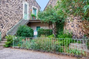 a building with a staircase and a fence at La Coustouline in Lacoste
