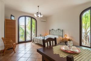 a living room with a bed and a dining table at Monolocale 900 in Racale