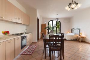 a kitchen and dining room with a table and a bed at Monolocale 900 in Racale +8 photos