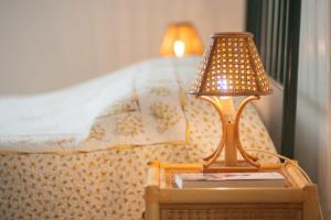 a lamp on a table next to a bed at Monolocale 900 in Racale
