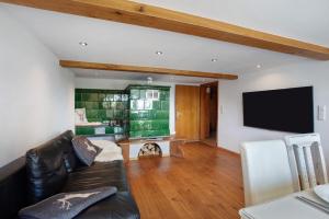 a living room with a couch and a flat screen tv at Black Forest Woods in Bernau im Schwarzwald