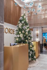 a christmas tree in the lobby of a office at Concorde Hotel New York in New York
