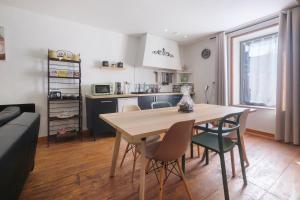 a kitchen and dining room with a table and chairs at La Perle Rosée in Azerat