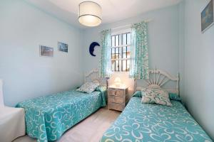 a bedroom with two beds and a window at Espiritu Santo Velero 54 in Sanlúcar de Barrameda