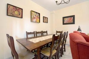 a dining room with a wooden table and chairs at Espiritu Santo Velero 54 in Sanlúcar de Barrameda +14 photos