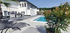 a villa with a swimming pool and a house at Fewo Harzblick Goslar mit Pool in Goslar