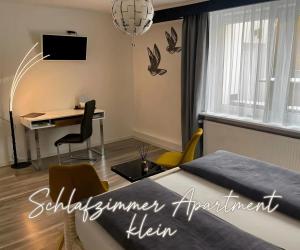 a bedroom with a desk and a bed in a room at Fewo Harzblick Goslar mit Pool in Goslar