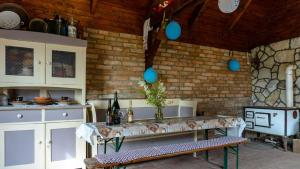 a kitchen with a table and some blue balloons at Szilvaliget Vendégház in Tolcsva