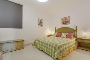 a bedroom with a bed and a flat screen tv at Casa Paradise Jannest in Adeje +20 photos