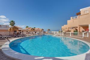 a large swimming pool in front of a hotel at Casa Paradise Jannest in Adeje