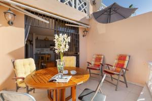 a dining room with a wooden table and chairs at Casa Paradise Jannest in Adeje