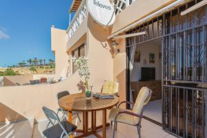 a balcony with a wooden table and chairs at Casa Paradise Jannest in Adeje