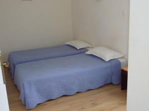 two beds sitting next to each other in a room at Villa Pigna in Pigna