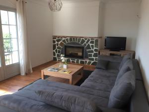a living room with a couch and a fireplace at Villa Pigna in Pigna