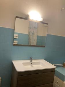 a bathroom with a sink and a mirror at Villa Pigna in Pigna +34 photos