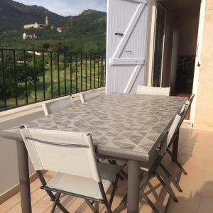 a table and chairs on a balcony with a view at Villa Pigna in Pigna