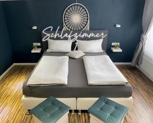 a bedroom with two beds and a sign that reads saturday summer at Fewo Harzblick Goslar mit Pool in Goslar +28 photos