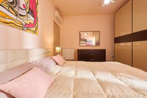a bedroom with a large white bed in it at Rosamare - Follonica in Follonica
