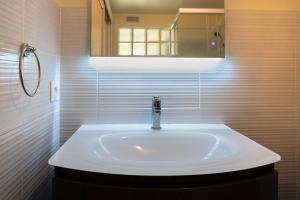 a white sink in a bathroom with a mirror at Au Coeur De Plouguerneau in Plouguerneau +16 photos