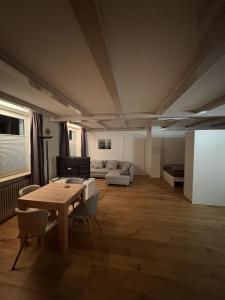 a living room with a table and a couch at Moderne Ferienwohnung Bodensee in Sigmarszell