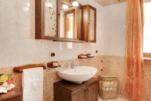 a bathroom with a white sink and a mirror at Clematis in Cisterna dʼAsti +19 photos