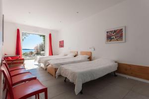 a row of beds in a room with a window at Ventaou in Sainte-Maxime +37 photos